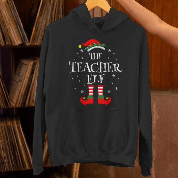 The Teacher Elf Christmas Family Matching Group Xmas Unisex Hoodie, gift for family, gift for coworker The Teacher Elf Christmas Family Matching Group Xmas Unisex Hoodie, gift for family, gift for coworker