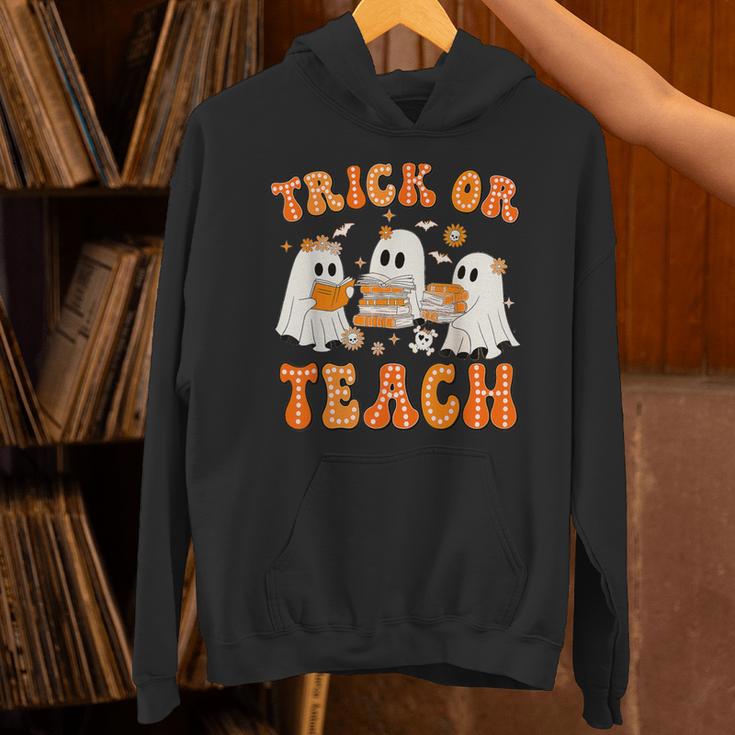 Teacher Halloween Trick Or Teach Retro Groovy Floral Ghost Unisex Hoodie, Groovy Teacher Hoodies, gift for family, gift for coworker Teacher Halloween Trick Or Teach Retro Groovy Floral Ghost Unisex Hoodie, Groovy Teacher Hoodies, gift for family, gift for coworker
