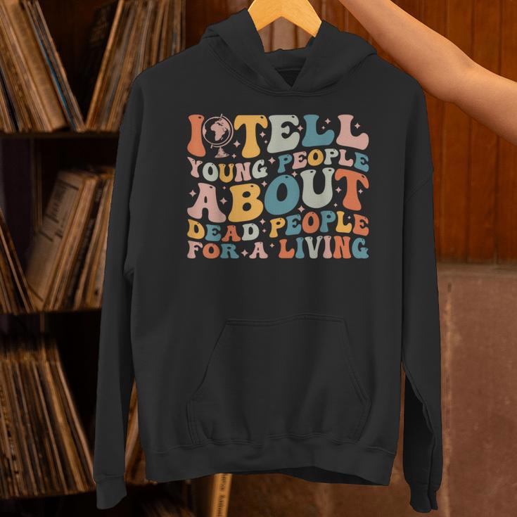 I Tell Young People About Dead People Groovy History Teacher Unisex Hoodie, History Teacher Hoodies, Groovy Teacher Hoodies, gift for family, gift for coworker I Tell Young People About Dead People Groovy History Teacher Unisex Hoodie, History Teacher Hoodies, Groovy Teacher Hoodies, gift for family, gift for coworker