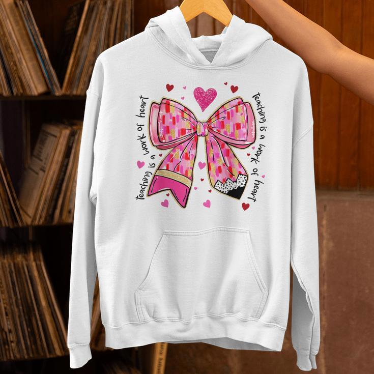 Teaching Is A Work Of Heart Pencil Bow Teacher Valentine Unisex Hoodie, gift for family, gift for coworker Teaching Is A Work Of Heart Pencil Bow Teacher Valentine Unisex Hoodie, gift for family, gift for coworker