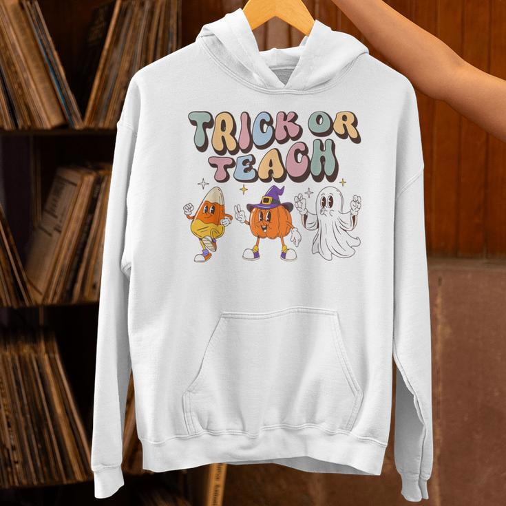 Trick Or Teach Candy Corn Pumpkin Ghost Teacher Unisex Hoodie, gift for family, gift for coworker Trick Or Teach Candy Corn Pumpkin Ghost Teacher Unisex Hoodie, gift for family, gift for coworker