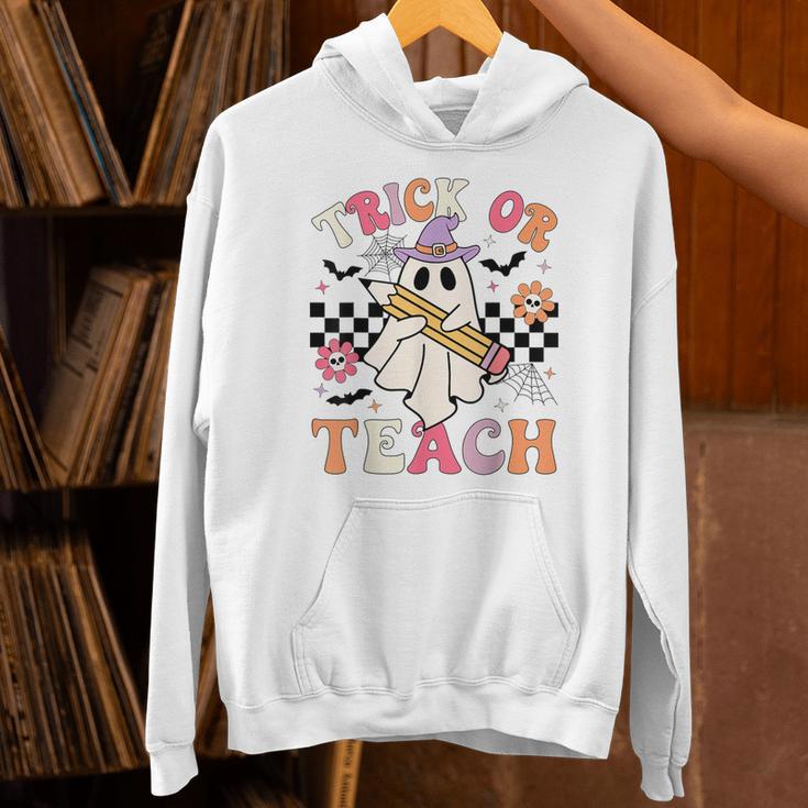 Trick Or Teach Groovy Teacher Halloween Retro Floral Ghost Unisex Hoodie, Groovy Teacher Hoodies, gift for family, gift for coworker