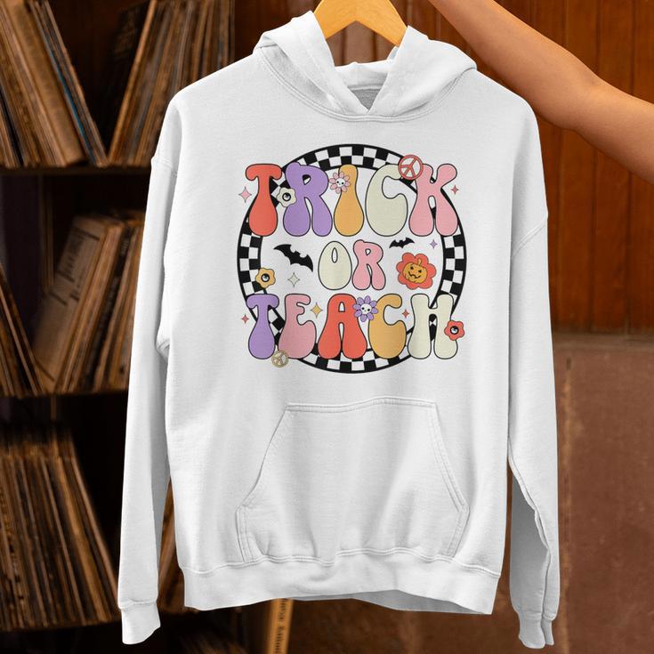 Trick Or Teach Retro Groovy Halloween Teacher Unisex Hoodie, Groovy Teacher Hoodies, gift for family, gift for coworker