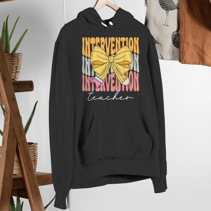 Interventionist Teacher Groovy Coquette Bow Back To School Women's Hoodie, Groovy Teacher Hoodies, funny gift Interventionist Teacher Groovy Coquette Bow Back To School Women's Hoodie, Groovy Teacher Hoodies, funny gift