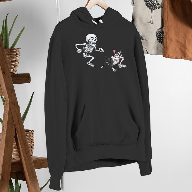 Skeleton Chasing Dog Boston Terrier Halloween Pet Lover Women's Hoodie, Boston Terrier Halloween Hoodies, funny gift