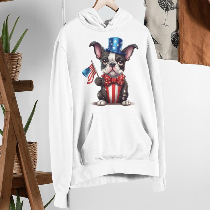 Boston Terrier Puppy Dog Holds His American Flag 4th Of July Women's Hoodie, American Boston Terrier Hoodies, Boston Terrier 4th Of July Hoodies, funny gift