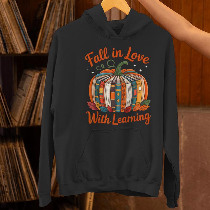 Fall In Love With Learning Book Lover Autumn Pumpkin Teacher Women's Hoodie, gift for family, gift for coworker