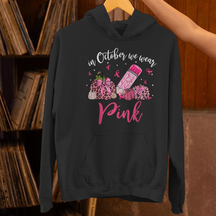 In October We Wear Pink Apple Teacher Daisy Breast Cancer Women's Hoodie, gift for family, gift for coworker In October We Wear Pink Apple Teacher Daisy Breast Cancer Women's Hoodie, gift for family, gift for coworker