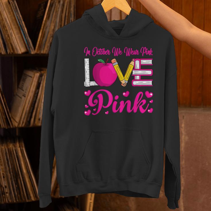 In October We Wear Pink Love Teacher Breast Cancer Awareness Women's Hoodie, gift for family, gift for coworker In October We Wear Pink Love Teacher Breast Cancer Awareness Women's Hoodie, gift for family, gift for coworker