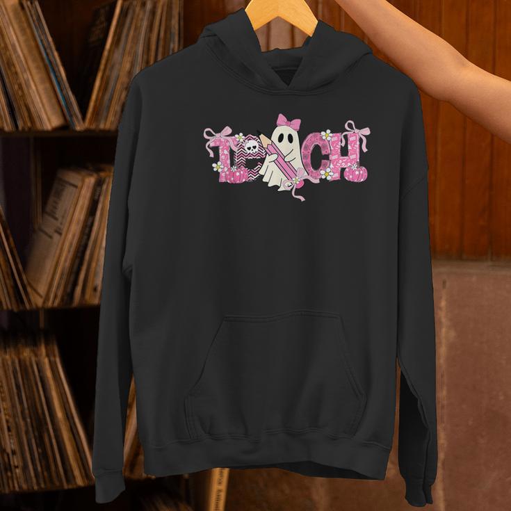 Pink Ghost Teach Halloween Teacher In Spooky Season Women's Hoodie, gift for family, gift for coworker Pink Ghost Teach Halloween Teacher In Spooky Season Women's Hoodie, gift for family, gift for coworker