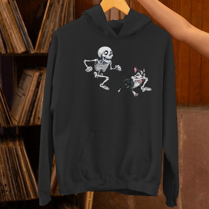 Skeleton Chasing Dog Boston Terrier Halloween Pet Lover Women's Hoodie, Boston Terrier Halloween Hoodies, gift for family, gift for coworker
