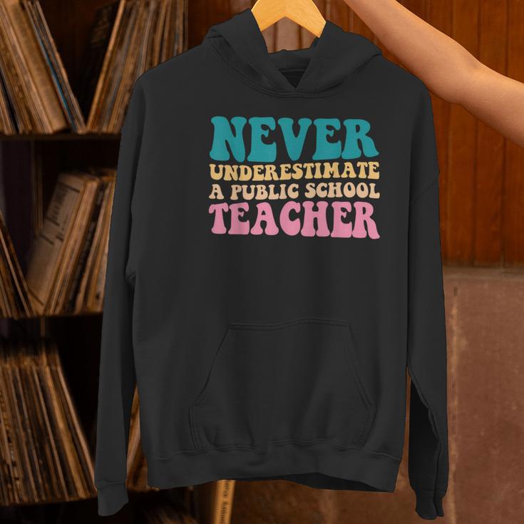 Never Underestimate A Public School Teacher Groovy Women Women's Hoodie, Groovy Teacher Hoodies, gift for family, gift for coworker Never Underestimate A Public School Teacher Groovy Women Women's Hoodie, Groovy Teacher Hoodies, gift for family, gift for coworker