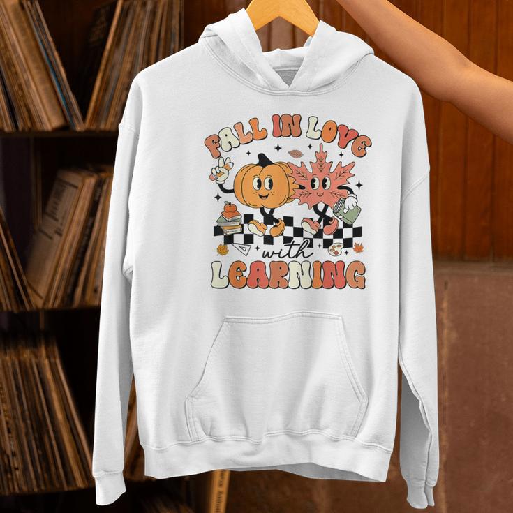Fall In Love With Learning Teacher Retro Thanksgiving Women's Hoodie, gift for family, gift for coworker