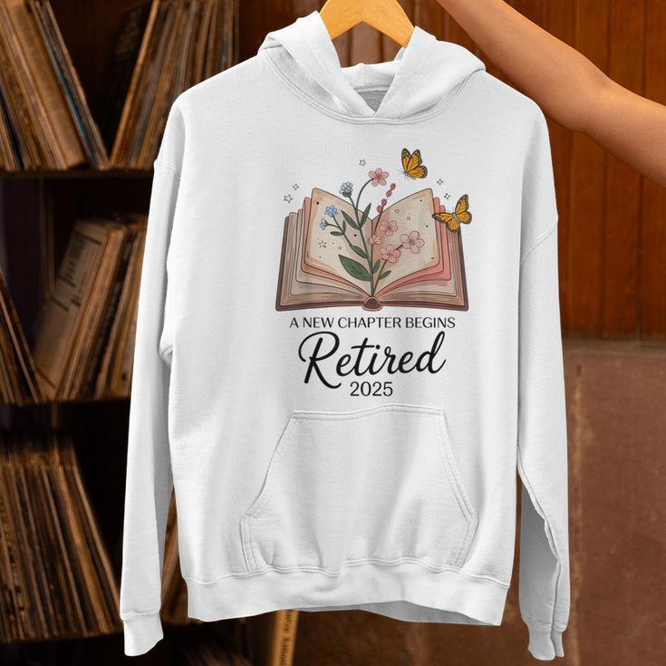 Retired 2025 A New Chapter Begins Retirement Teacher Book Women's Hoodie, gift for family, gift for coworker