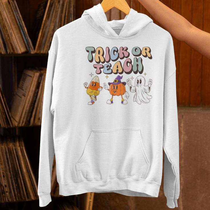 Trick Or Teach Candy Corn Pumpkin Ghost Teacher Women's Hoodie, gift for family, gift for coworker