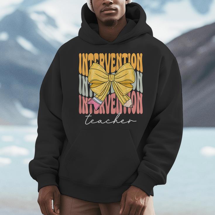 Interventionist Teacher Groovy Coquette Bow Back To School Men Hoodie, Groovy Teacher Gifts, funny design