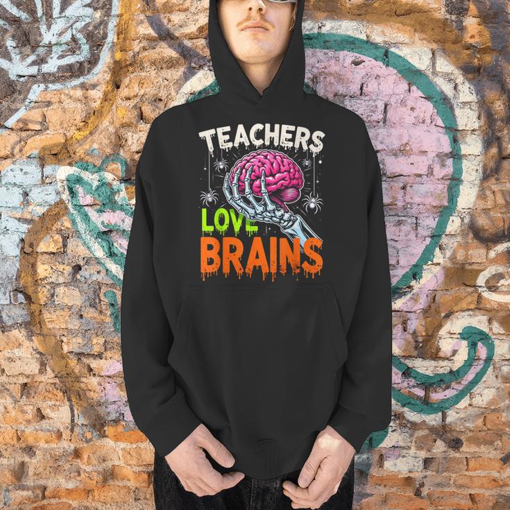 Teachers Love Brains Halloween 2025 Skeleton Costume Men Hoodie, gift for family, gift for coworker Teachers Love Brains Halloween 2025 Skeleton Costume Men Hoodie, gift for family, gift for coworker