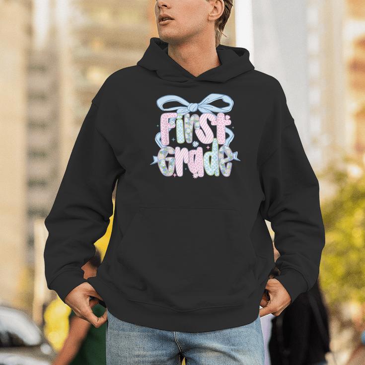 First Grade Coquette Bow Girls Teacher Team 1st Grade Squad Men Hoodie, First Grade Teacher Hoodies, funny gift