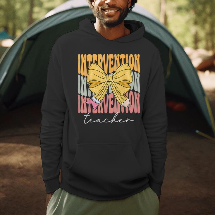 Interventionist Teacher Groovy Coquette Bow Back To School Men Hoodie, novelty gifts, funny gifts