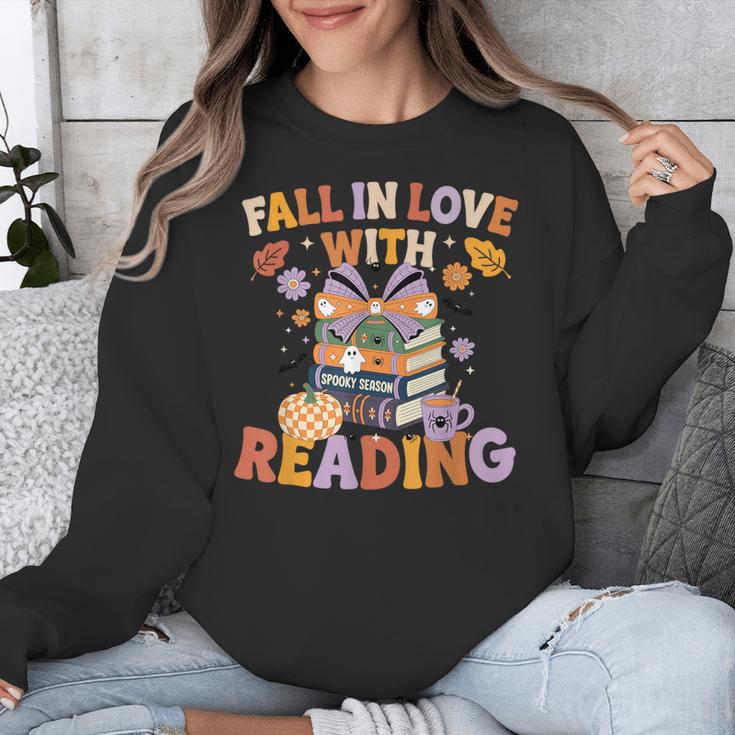 Fall In Love With Reading Halloween Stack Of Book Teacher Unisex Sweatshirt, funny design Fall In Love With Reading Halloween Stack Of Book Teacher Unisex Sweatshirt, funny design