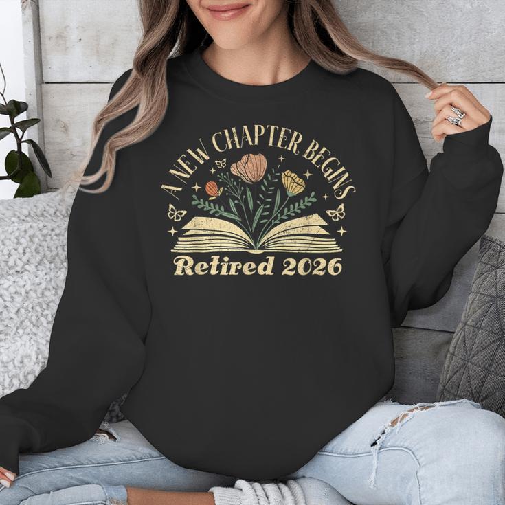 A New Chapter Begins Retired 2026 Teacher Retirement Unisex Sweatshirt, funny design A New Chapter Begins Retired 2026 Teacher Retirement Unisex Sweatshirt, funny design