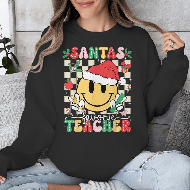 Santas Favorite Teacher Retro Groovy Smile Face Christmas Unisex Sweatshirt, Groovy Teacher Gifts, funny design Santas Favorite Teacher Retro Groovy Smile Face Christmas Unisex Sweatshirt, Groovy Teacher Gifts, funny design