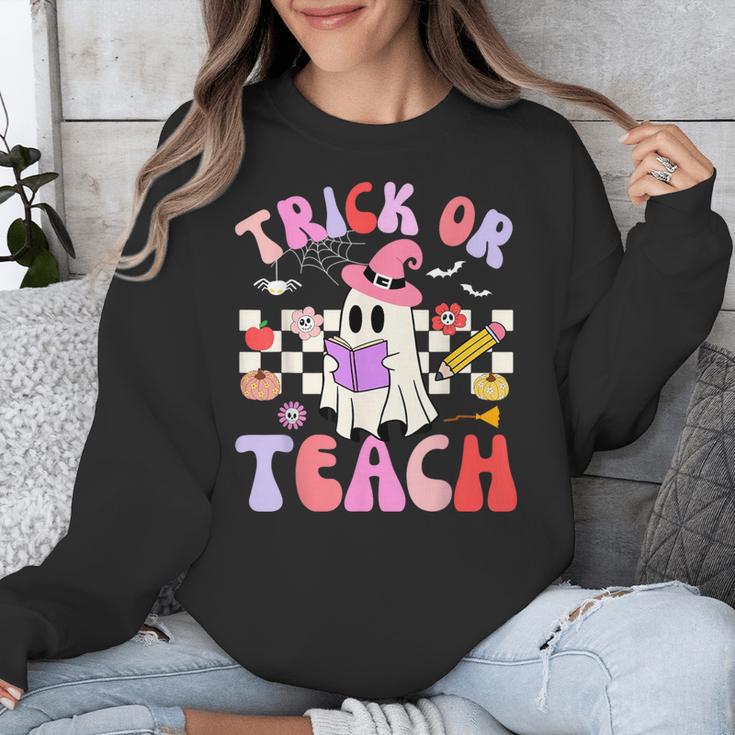Trick Or Teach Halloween Teacher Floral Ghost Groovy Unisex Sweatshirt, Groovy Teacher Gifts, funny design Trick Or Teach Halloween Teacher Floral Ghost Groovy Unisex Sweatshirt, Groovy Teacher Gifts, funny design