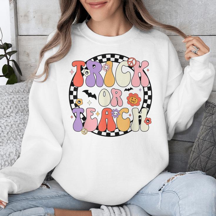 Trick Or Teach Retro Groovy Halloween Teacher Unisex Sweatshirt, Groovy Teacher Gifts, funny design Trick Or Teach Retro Groovy Halloween Teacher Unisex Sweatshirt, Groovy Teacher Gifts, funny design