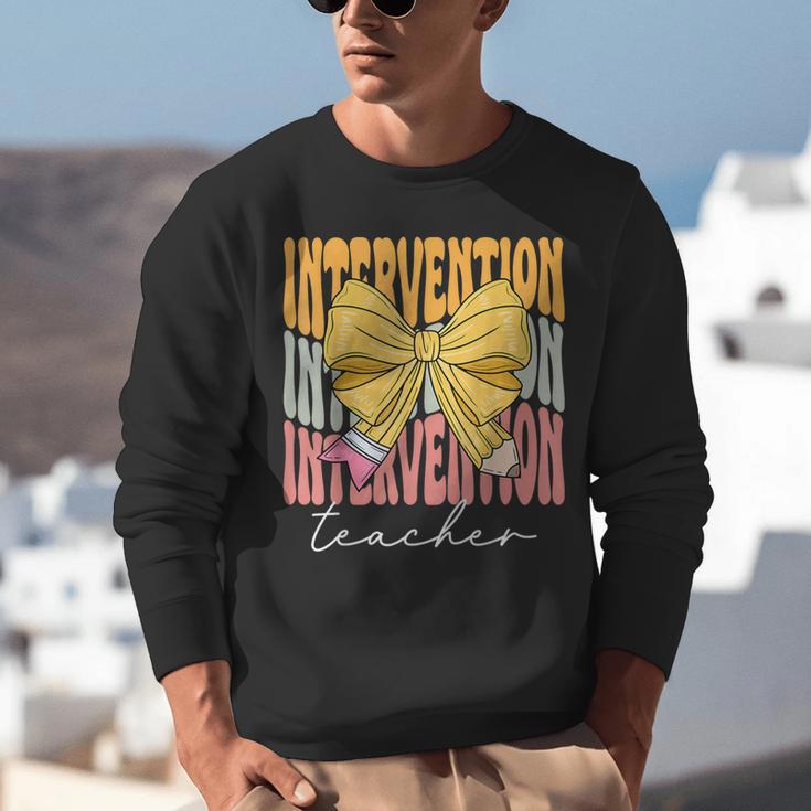 Interventionist Teacher Groovy Coquette Bow Back To School Unisex Sweatshirt, Groovy Teacher Sweatshirts, funny gift