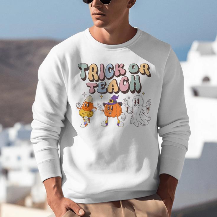 Trick Or Teach Candy Corn Pumpkin Ghost Teacher Unisex Sweatshirt, funny gift Trick Or Teach Candy Corn Pumpkin Ghost Teacher Unisex Sweatshirt, funny gift