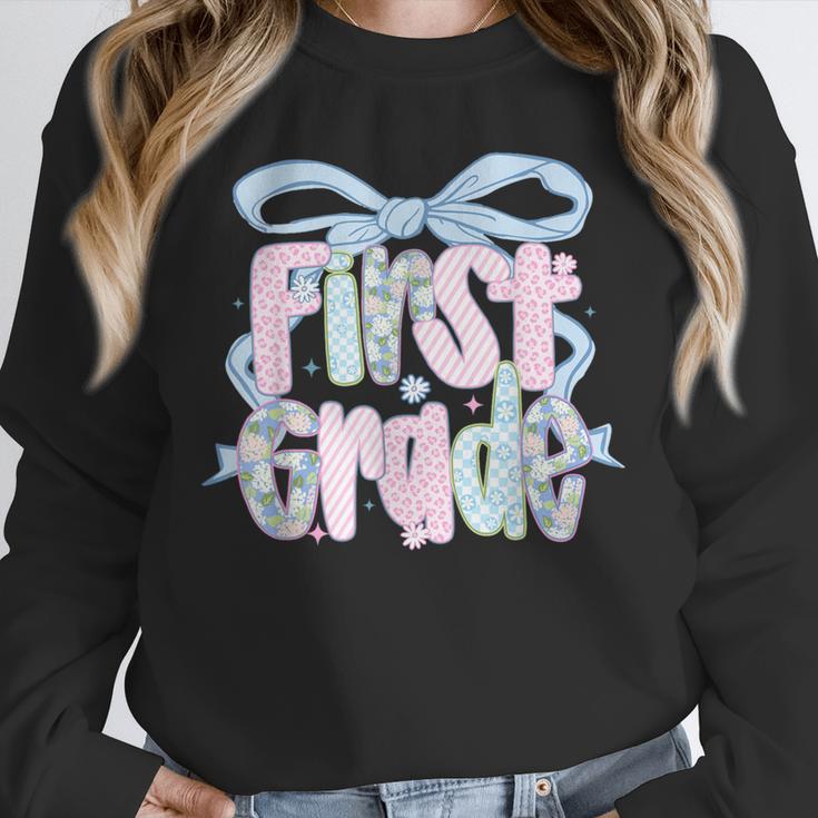 First Grade Coquette Bow Girls Teacher Team 1st Grade Squad Unisex Sweatshirt, novelty gifts, funny gifts