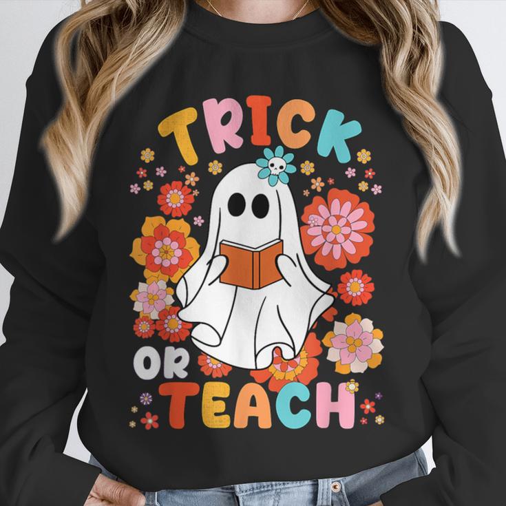 Groovy Halloween Trick Or Teach Retro Floral Ghost Teacher For Men Women Kids Unisex Sweatshirt, novelty gifts, funny gifts Groovy Halloween Trick Or Teach Retro Floral Ghost Teacher For Men Women Kids Unisex Sweatshirt, novelty gifts, funny gifts