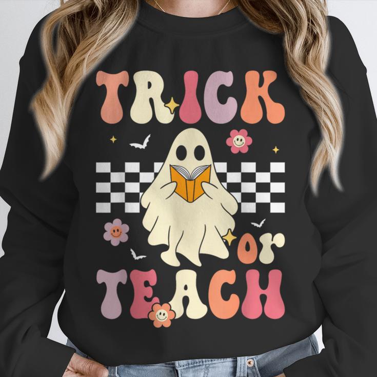 Groovy Teacher Halloween Retro Trick Or Teach Floral Ghost Unisex Sweatshirt, novelty gifts, funny gifts
