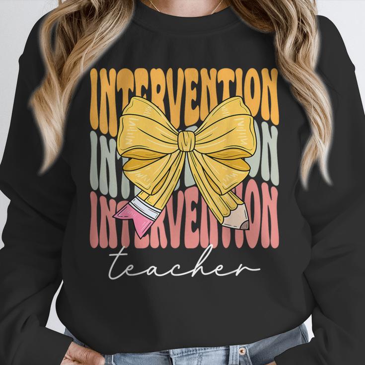 Interventionist Teacher Groovy Coquette Bow Back To School Unisex Sweatshirt, novelty gifts, funny gifts