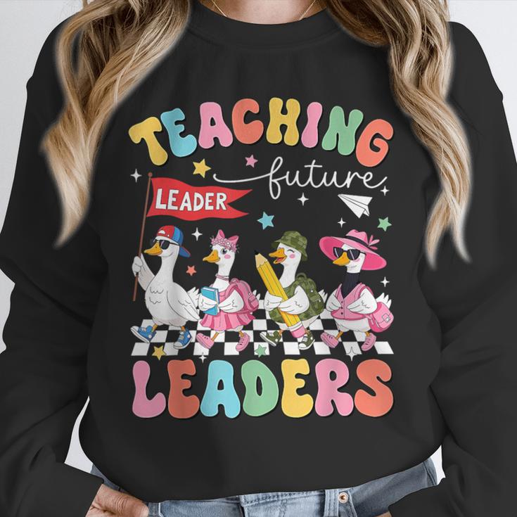 Teaching Future Leaders Groovy Teacher Back To School Unisex Sweatshirt, novelty gifts, funny gifts
