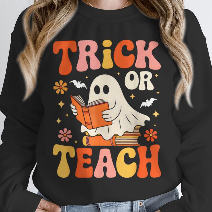 Trick Or Teach Halloween Shirt For Teacher Kids Floral Ghost Unisex Sweatshirt, novelty gifts, funny gifts Trick Or Teach Halloween Shirt For Teacher Kids Floral Ghost Unisex Sweatshirt, novelty gifts, funny gifts
