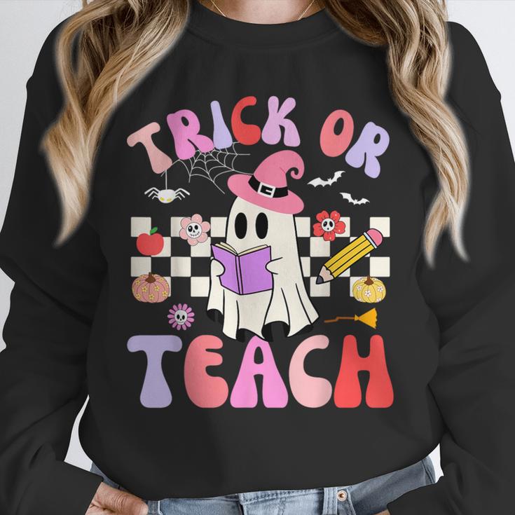 Trick Or Teach Halloween Teacher Floral Ghost Groovy Unisex Sweatshirt, novelty gifts, funny gifts Trick Or Teach Halloween Teacher Floral Ghost Groovy Unisex Sweatshirt, novelty gifts, funny gifts