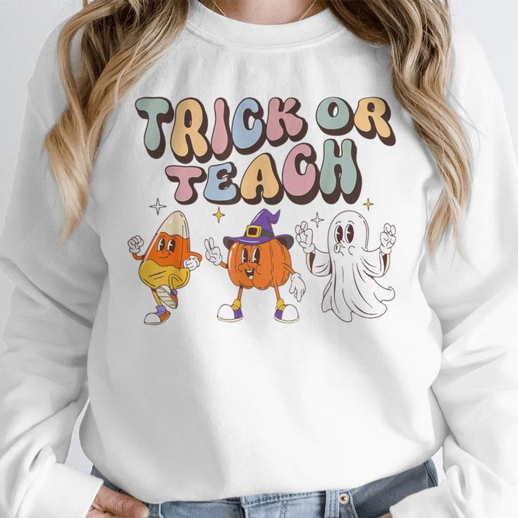 Trick Or Teach Candy Corn Pumpkin Ghost Teacher Unisex Sweatshirt, novelty gifts, funny gifts Trick Or Teach Candy Corn Pumpkin Ghost Teacher Unisex Sweatshirt, novelty gifts, funny gifts