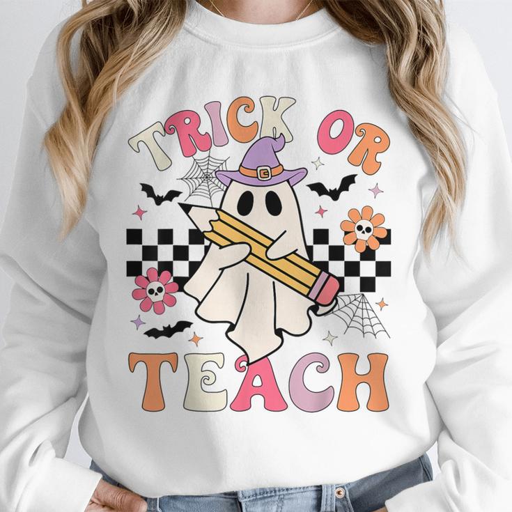 Trick Or Teach Groovy Teacher Halloween Retro Floral Ghost Unisex Sweatshirt, novelty gifts, funny gifts Trick Or Teach Groovy Teacher Halloween Retro Floral Ghost Unisex Sweatshirt, novelty gifts, funny gifts