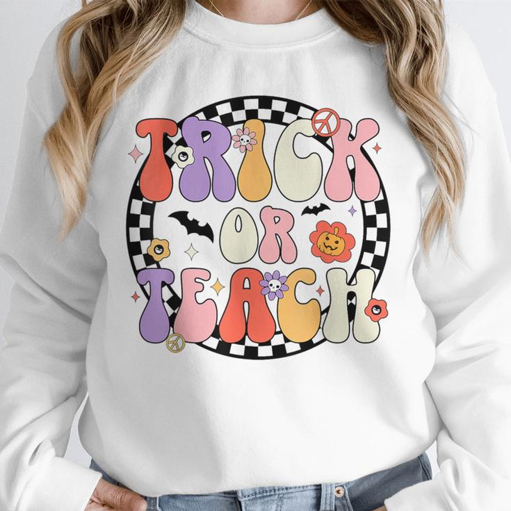 Trick Or Teach Retro Groovy Halloween Teacher Unisex Sweatshirt, novelty gifts, funny gifts Trick Or Teach Retro Groovy Halloween Teacher Unisex Sweatshirt, novelty gifts, funny gifts