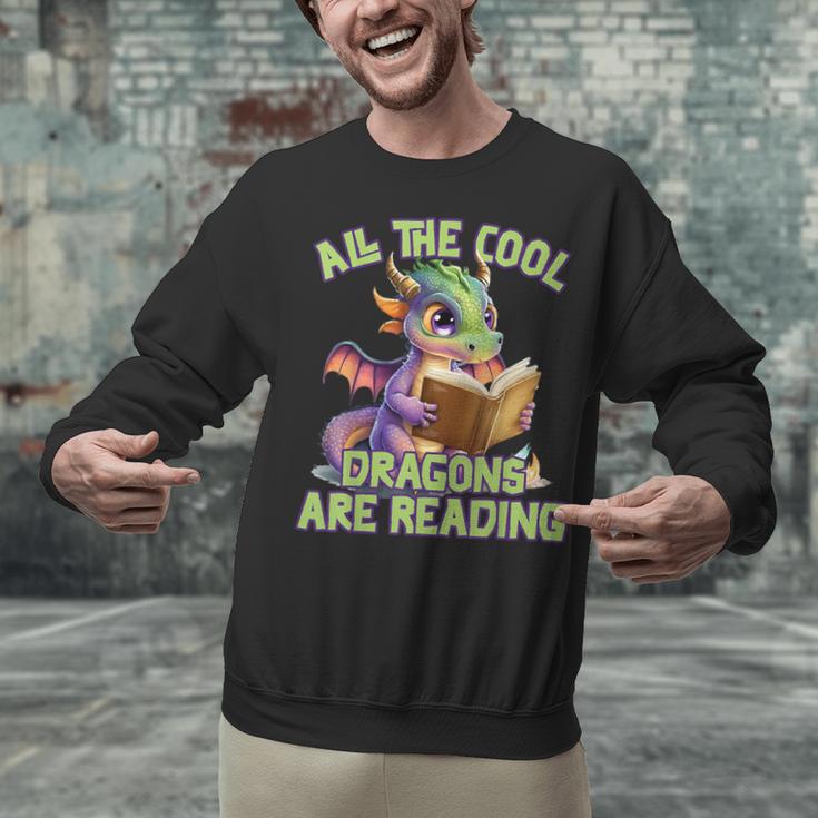 All The Cool Dragons Are Reading Dragon Teacher Unisex Sweatshirt, gift for family, gift for coworker All The Cool Dragons Are Reading Dragon Teacher Unisex Sweatshirt, gift for family, gift for coworker