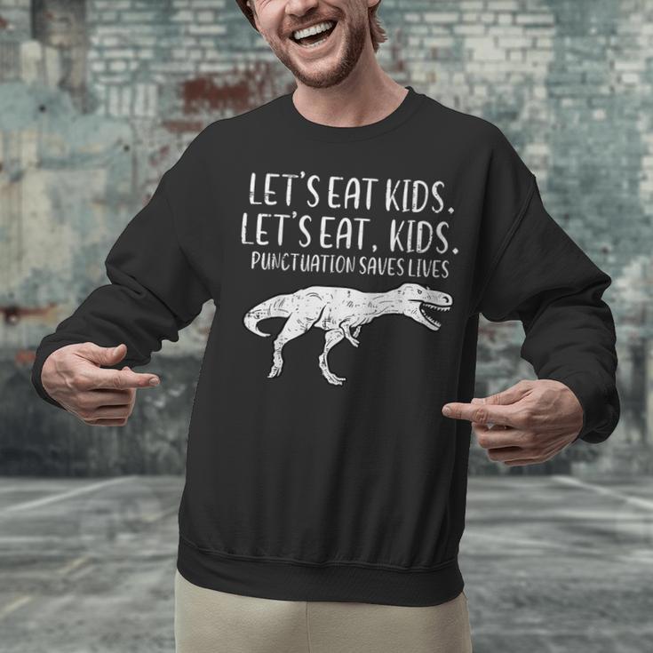 Lets Eat Kids Punctuation Saves Lives Dino Teacher Men Unisex Sweatshirt, gift for family, gift for coworker Lets Eat Kids Punctuation Saves Lives Dino Teacher Men Unisex Sweatshirt, gift for family, gift for coworker
