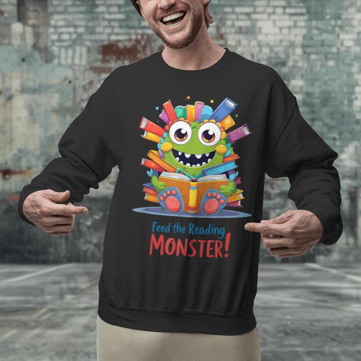 Feed The Reading Monster Halloween Teacher Unisex Sweatshirt, gift for family, gift for coworker Feed The Reading Monster Halloween Teacher Unisex Sweatshirt, gift for family, gift for coworker