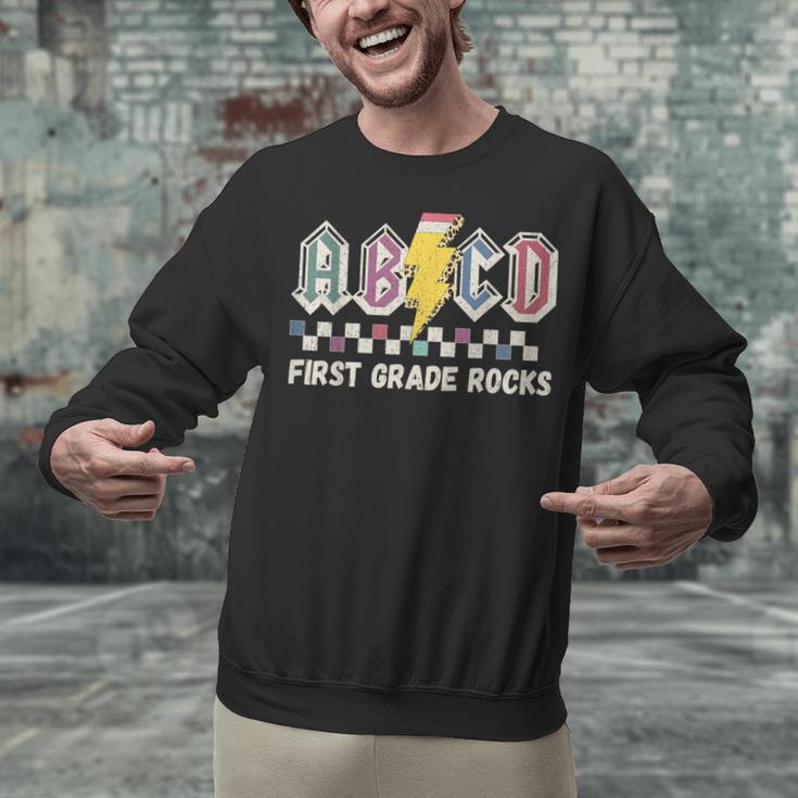First Grade Rocks Teachers Back To School ABCD Rock Students Unisex Sweatshirt, First Grade Teacher Sweatshirts, gift for family, gift for coworker First Grade Rocks Teachers Back To School ABCD Rock Students Unisex Sweatshirt, First Grade Teacher Sweatshirts, gift for family, gift for coworker