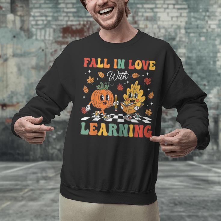 Groovy Fall In Love With Learning Autumn Pumpkin Teacher Unisex Sweatshirt, Groovy Teacher Sweatshirts, gift for family, gift for coworker Groovy Fall In Love With Learning Autumn Pumpkin Teacher Unisex Sweatshirt, Groovy Teacher Sweatshirts, gift for family, gift for coworker