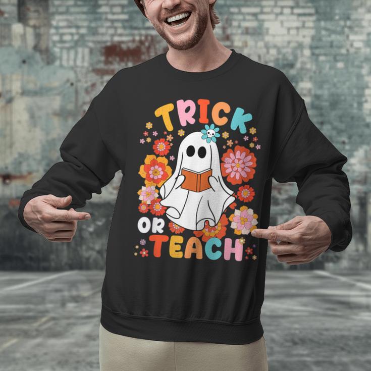 Groovy Halloween Trick Or Teach Retro Floral Ghost Teacher For Men Women Kids Unisex Sweatshirt, Groovy Teacher Sweatshirts, gift for family, gift for coworker Groovy Halloween Trick Or Teach Retro Floral Ghost Teacher For Men Women Kids Unisex Sweatshirt, Groovy Teacher Sweatshirts, gift for family, gift for coworker