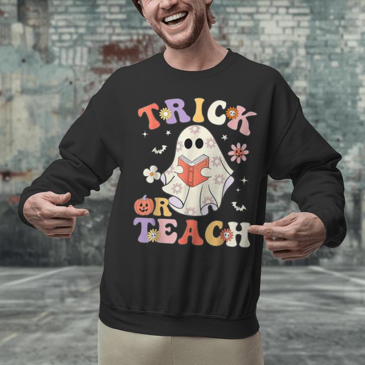 Groovy Halloween Trick Or Teach Retro Floral Ghost Teacher Unisex Sweatshirt, Groovy Teacher Sweatshirts, gift for family, gift for coworker Groovy Halloween Trick Or Teach Retro Floral Ghost Teacher Unisex Sweatshirt, Groovy Teacher Sweatshirts, gift for family, gift for coworker