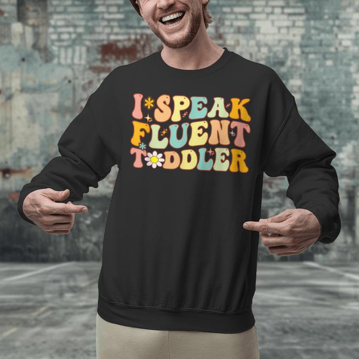 Groovy I Speak Fluent Toddler Daycare Provider Teacher Unisex Sweatshirt, Groovy Teacher Sweatshirts, gift for family, gift for coworker Groovy I Speak Fluent Toddler Daycare Provider Teacher Unisex Sweatshirt, Groovy Teacher Sweatshirts, gift for family, gift for coworker