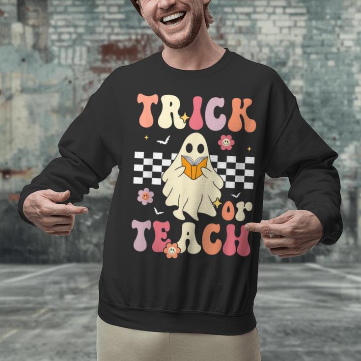 Groovy Teacher Halloween Retro Trick Or Teach Floral Ghost Unisex Sweatshirt, Groovy Teacher Sweatshirts, gift for family, gift for coworker