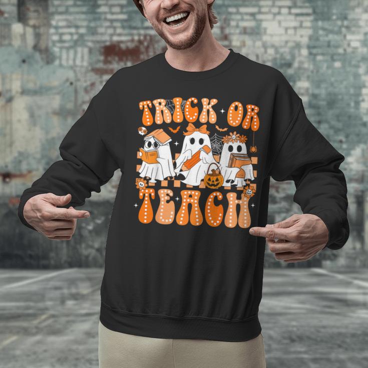 Groovy Teacher Halloween Trick Or Teach Ghost Men Women Kids Unisex Sweatshirt, Groovy Teacher Sweatshirts, gift for family, gift for coworker Groovy Teacher Halloween Trick Or Teach Ghost Men Women Kids Unisex Sweatshirt, Groovy Teacher Sweatshirts, gift for family, gift for coworker